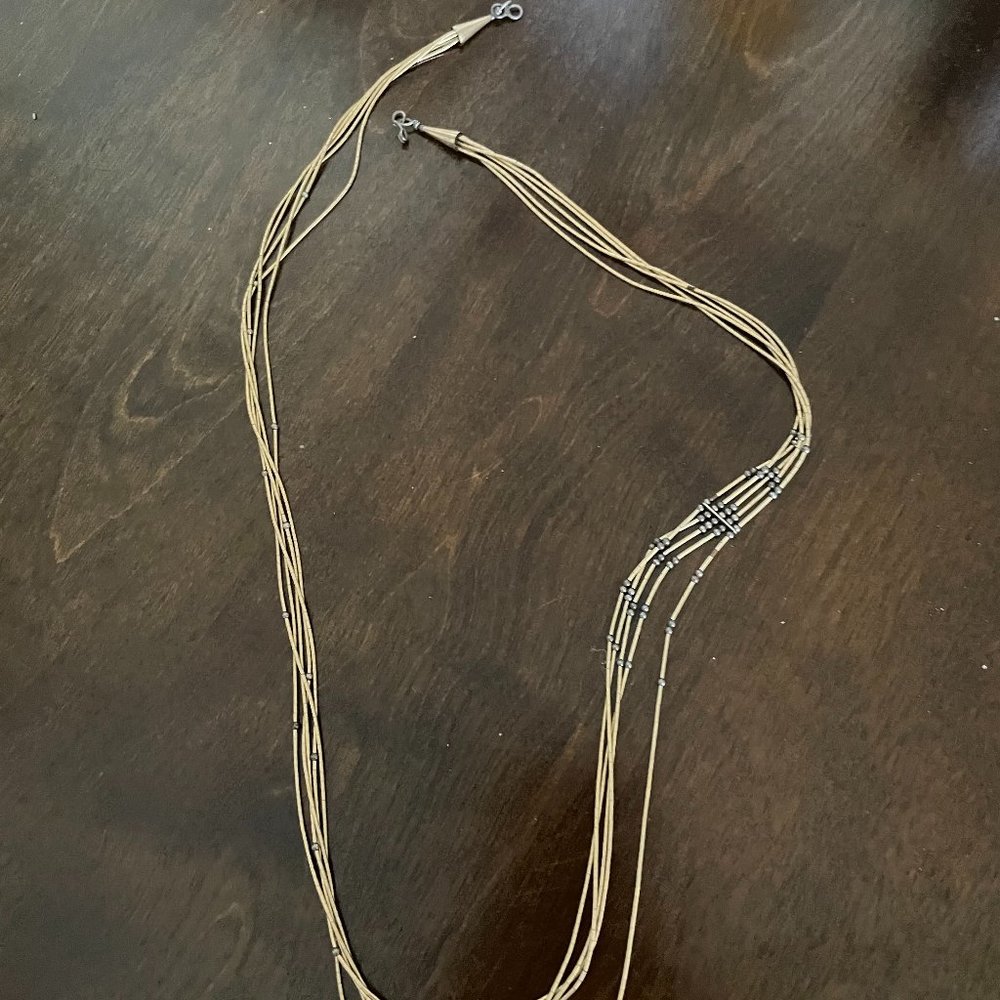 14k GOLD MULTI STRAND NECKLAS WITH ASYMETRICAL DETAIL ON RIGHT SIDE